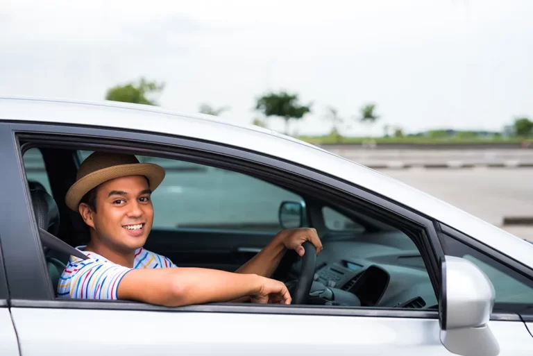man smiling in car happy with not at fault claim